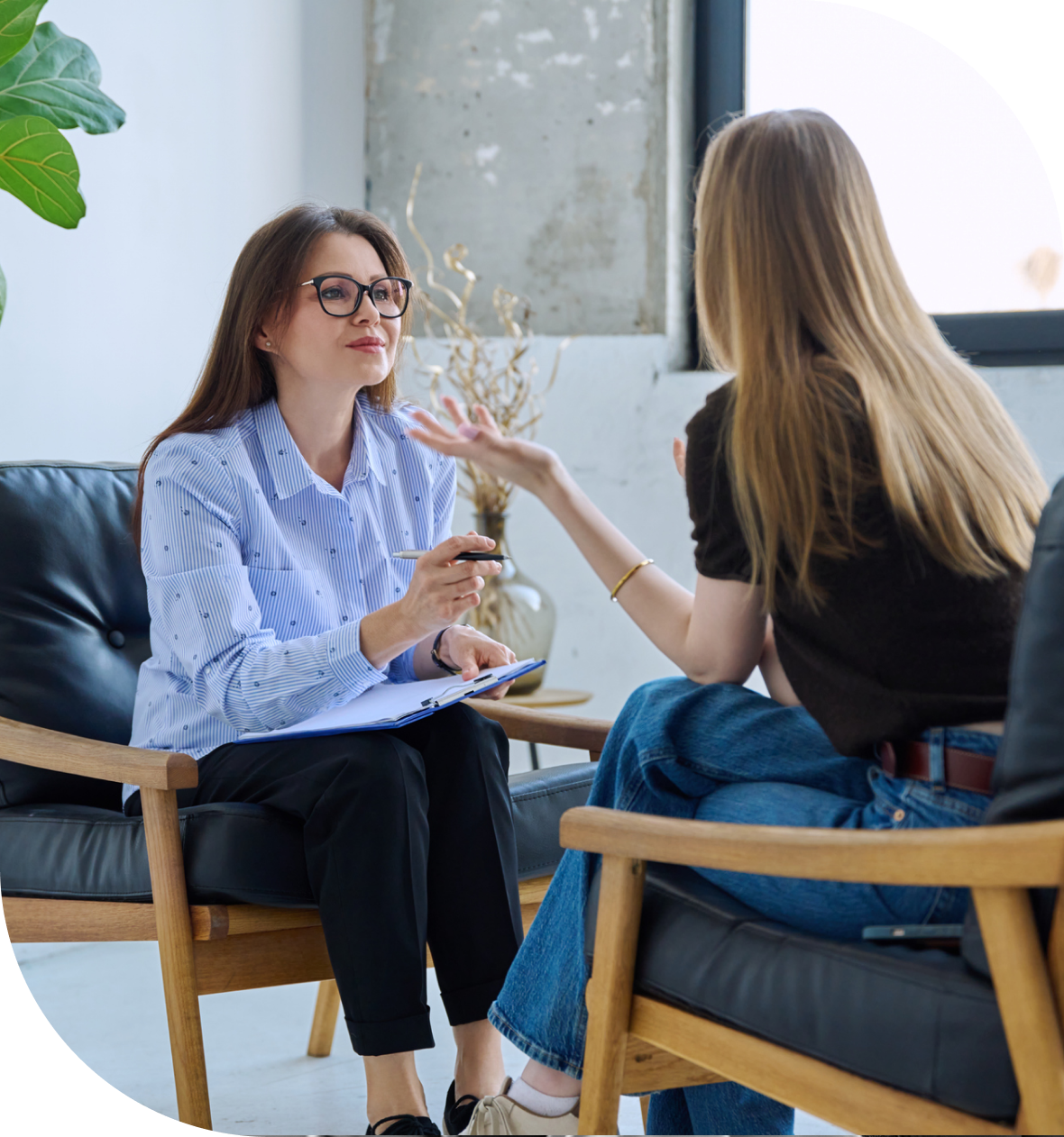 Two women having a conversation in office.